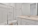 Clean bathroom featuring a tiled walk-in shower, toilet, and a vanity with a sink and storage at 5410 Catmint Dr, Lake Hamilton, FL 33851