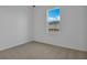 Cozy bedroom with neutral carpet and a window offering natural light at 5410 Catmint Dr, Lake Hamilton, FL 33851