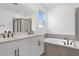 Bathroom with dual sink vanity, soaking tub and large window for natural light at 4060 Bannock Ave, Tavares, FL 32778