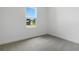 A well-lit bedroom with neutral carpet and a large window at 4060 Bannock Ave, Tavares, FL 32778
