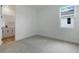 Bright bedroom with plush carpeting, neutral walls, and ensuite bath access at 4060 Bannock Ave, Tavares, FL 32778