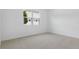Bright bedroom featuring plush carpeting, neutral walls, and a window with a view at 4060 Bannock Ave, Tavares, FL 32778