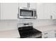 Modern stainless steel microwave and black glass top range at 4060 Bannock Ave, Tavares, FL 32778