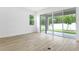 Bright living room featuring sliding glass doors leading to an outdoor patio at 4060 Bannock Ave, Tavares, FL 32778