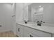 Bathroom features double sink vanity with white cabinets, black hardware, and walk-in shower and tub at 4064 Bannock Ave, Tavares, FL 32778