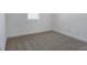 Bedroom featuring plush gray carpeting, white walls and trim, plus a window providing natural light at 4064 Bannock Ave, Tavares, FL 32778
