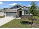 Charming single-Gathering home with stone accents, well-kept landscaping, and a two-car garage at 4064 Bannock Ave, Tavares, FL 32778