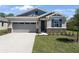 Charming single-Gathering home with stone accents, well-kept landscaping, and a two-car garage at 4064 Bannock Ave, Tavares, FL 32778