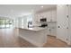 Bright, open kitchen with white cabinetry, stainless steel appliances, and a spacious island at 4064 Bannock Ave, Tavares, FL 32778