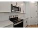 Close up of the kitchen with stainless steel oven, microwave, white cabinets and subway tile backsplash at 4064 Bannock Ave, Tavares, FL 32778