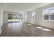 Spacious living room with wood-look floors and natural light from the sliding glass doors at 4064 Bannock Ave, Tavares, FL 32778