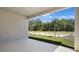 Covered patio overlooking a yard with young trees and view of treeline beyond at 4064 Bannock Ave, Tavares, FL 32778