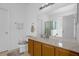 Bathroom with a large mirror over a wood vanity and a separate water closet at 4523 Ashtubula Ct, Orlando, FL 32818