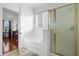 Bright bathroom featuring a soaking tub and glass-enclosed shower at 4523 Ashtubula Ct, Orlando, FL 32818