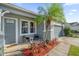 Inviting front porch with seating and a tropical palm tree at 4523 Ashtubula Ct, Orlando, FL 32818