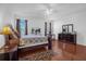 Spacious main bedroom featuring tray ceilings, wood floors, and lots of natural light at 4523 Ashtubula Ct, Orlando, FL 32818