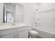 Clean bathroom with white cabinets, quartz countertop, and bathtub shower combo at 5406 Catmint Dr, Lake Hamilton, FL 33851