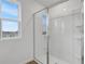 Bright bathroom featuring glass enclosed shower and window offering natural light at 5406 Catmint Dr, Lake Hamilton, FL 33851