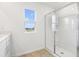 Bathroom showcasing a glass-enclosed shower, light walls, and wood-look tile flooring at 5406 Catmint Dr, Lake Hamilton, FL 33851