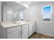 Bathroom featuring double sinks, quartz countertop, white cabinets, and wood-look tile flooring at 5406 Catmint Dr, Lake Hamilton, FL 33851