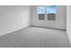 Bright bedroom featuring neutral walls, plush carpeting, and a window offering natural light at 5406 Catmint Dr, Lake Hamilton, FL 33851