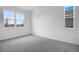 Cozy bedroom featuring neutral paint and wood-look flooring with bright sunny windows at 5406 Catmint Dr, Lake Hamilton, FL 33851