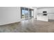 Open floor plan with sliding glass doors leading to the backyard and kitchen with white cabinets at 5406 Catmint Dr, Lake Hamilton, FL 33851