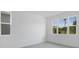 Bright bedroom featuring large windows providing great natural light and wood-look tile floors at 1769 Carnelian St, Deland, FL 32720
