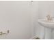 Pedestal sink with chrome hardware in a minimalist half bathroom with a tile floor at 1769 Carnelian St, Deland, FL 32720