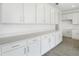 Bright kitchen featuring white cabinets, light countertops and stainless steel pulls at 1769 Carnelian St, Deland, FL 32720