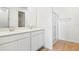 Modern bathroom featuring double vanity sinks, white cabinetry, and a glass-enclosed shower at 1771 Carnelian St, Deland, FL 32720