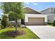 Charming single-Gathering home featuring a two-car garage and a well-manicured front lawn and stone facade at 1771 Carnelian St, Deland, FL 32720
