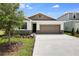 Charming single-Gathering home featuring a two-car garage and a well-manicured front lawn and stone facade at 1771 Carnelian St, Deland, FL 32720