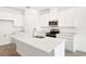 Bright kitchen with modern white cabinets, stainless steel appliances, and a central island at 1771 Carnelian St, Deland, FL 32720