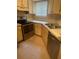 Kitchen featuring an oven, sink and wood cabinets at 1940 Lake Atriums Cir # 93, Orlando, FL 32839