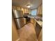 Galley kitchen featuring stainless steel appliances and wood cabinets at 1940 Lake Atriums Cir # 93, Orlando, FL 32839