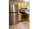 Kitchen featuring stainless steel refrigerator, oven and wood cabinets at 1940 Lake Atriums Cir # 93, Orlando, FL 32839