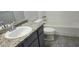 Updated bathroom with granite vanity and tile flooring at 2118 Allspice Ave, Orlando, FL 32837