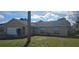 Tan one-story house with a white garage door and landscaping at 2118 Allspice Ave, Orlando, FL 32837