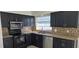 Modern kitchen with dark cabinets and granite countertops at 2118 Allspice Ave, Orlando, FL 32837