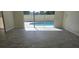 Living room with gray tile floor and sliding doors leading to a pool at 2118 Allspice Ave, Orlando, FL 32837