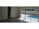Living room with gray tile floor and sliding doors leading to a pool at 2118 Allspice Ave, Orlando, FL 32837
