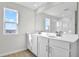 Bright bathroom features a double sink vanity, large mirror, and a shower with glass enclosure at 5418 Catmint Dr, Lake Hamilton, FL 33851
