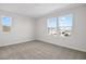 The bedroom is bright and airy and features neutral carpeting and three windows for natural light at 5418 Catmint Dr, Lake Hamilton, FL 33851