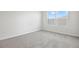 Empty bedroom featuring plush carpet, neutral walls, and abundant natural light at 5418 Catmint Dr, Lake Hamilton, FL 33851