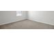 Bedroom with neutral carpeting, white walls, and a single window offering natural light at 5418 Catmint Dr, Lake Hamilton, FL 33851