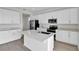 Modern kitchen featuring white cabinets, stainless steel appliances, and a center island at 5418 Catmint Dr, Lake Hamilton, FL 33851