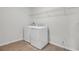 Laundry room features wood look tile flooring, new washer and dryer, and wire shelving at 5418 Catmint Dr, Lake Hamilton, FL 33851