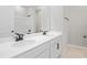 Bathroom featuring double vanity, sleek black fixtures, white cabinets, and a shower and tub combination at 5422 Catmint Dr, Lake Hamilton, FL 33851
