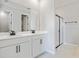 Modern bathroom with double sink vanity, white cabinets, and a glass-enclosed shower at 5422 Catmint Dr, Lake Hamilton, FL 33851